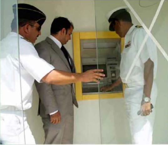 An ECOMS representative and Pakistan Navy officers at an ATM inauguration at Majeed SRE